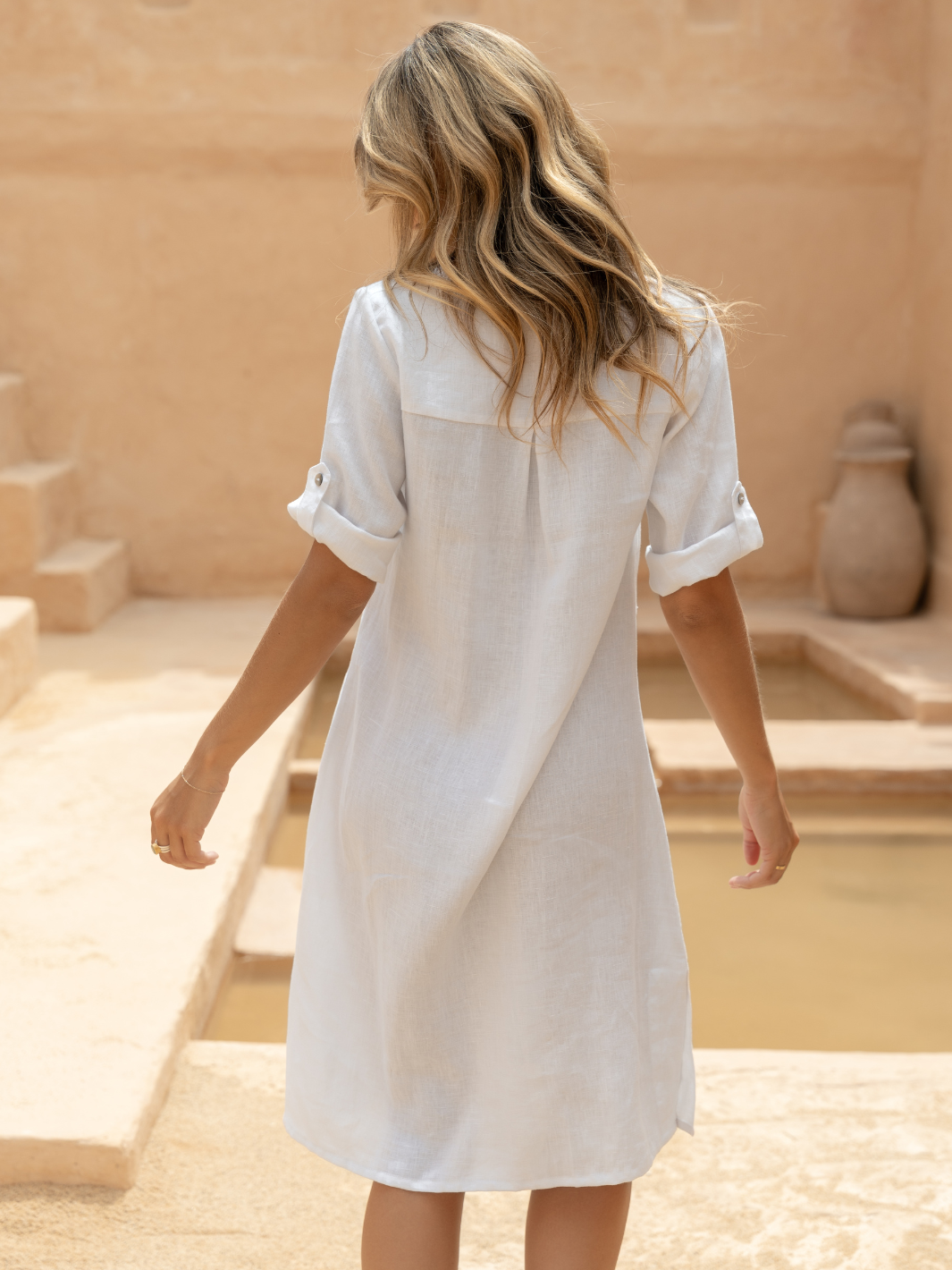Model wears Elyse French Linen Midi Dress in White