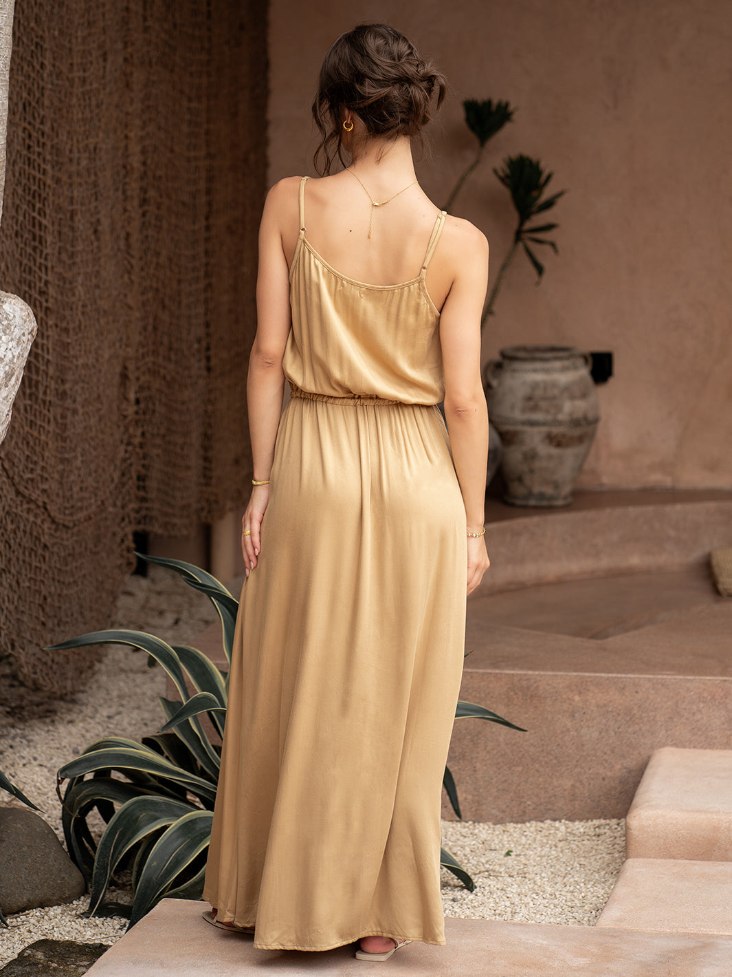 Woman wearing a gold dress.